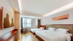 A hotel room with a large bed, a desk, and a chair. There is a painting on the wall and a window with curtains. - King Lycra Hotel(Shenzhen International Convention and Exhibition Center store) (Shenzhen)