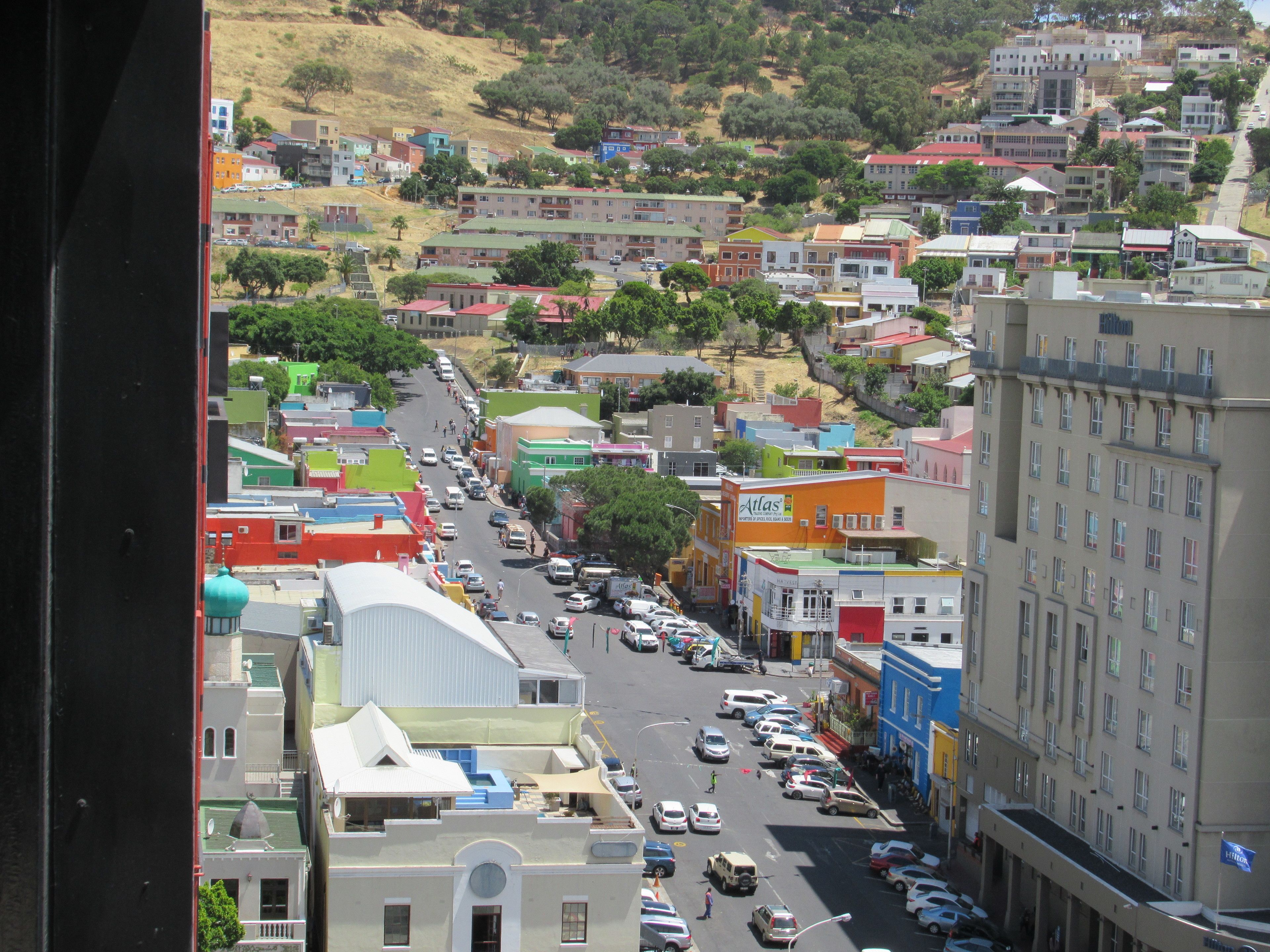 A cityscape with a variety of buildings, including a hotel with a prominent sign.