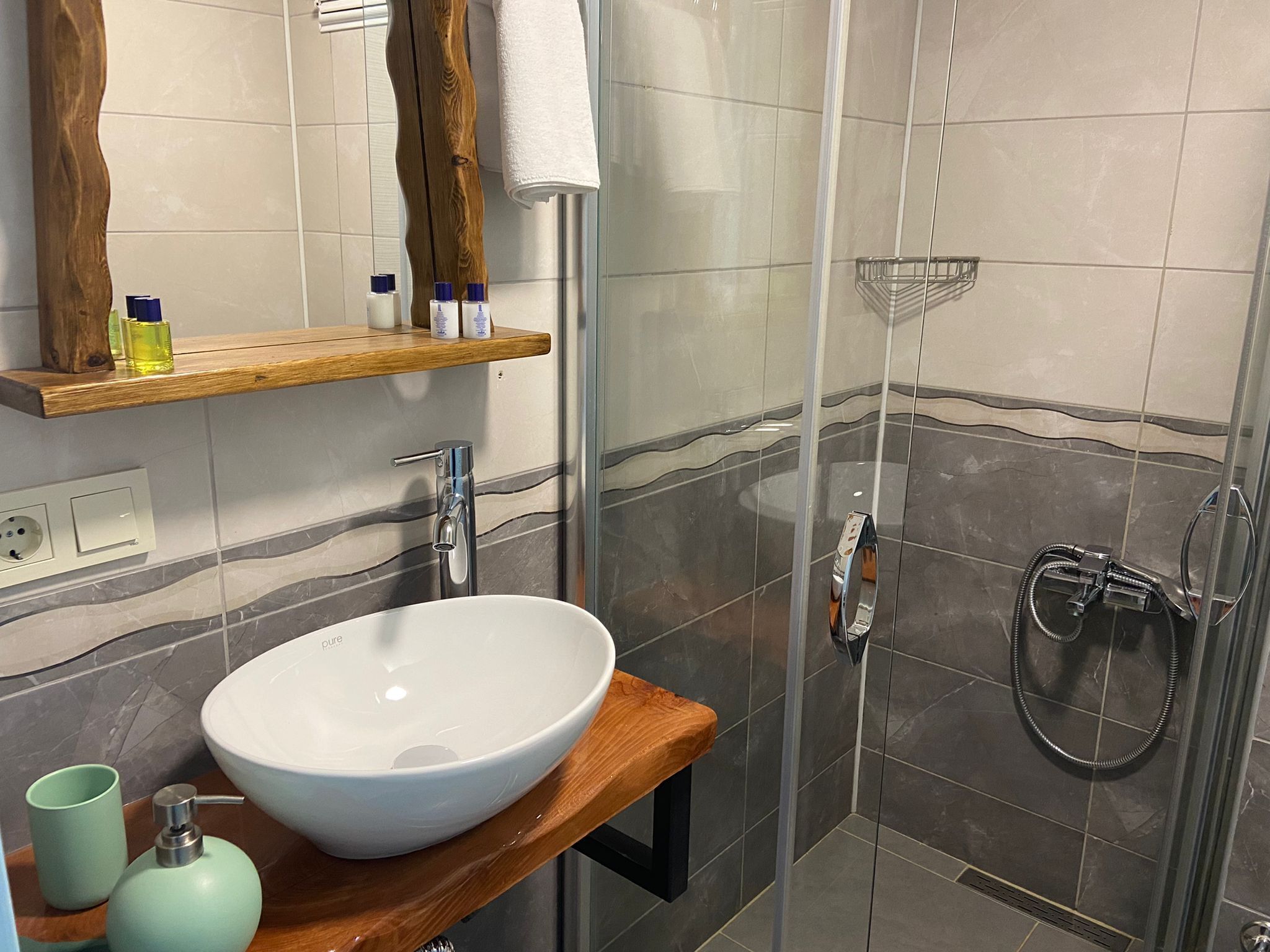 shower, hair dryer, slippers, towels