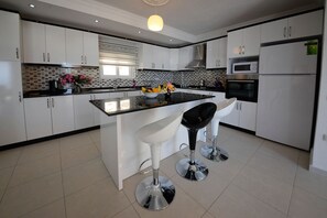 Villa, 4 Bedrooms | Private kitchenette | Full-size fridge, microwave, oven, stovetop