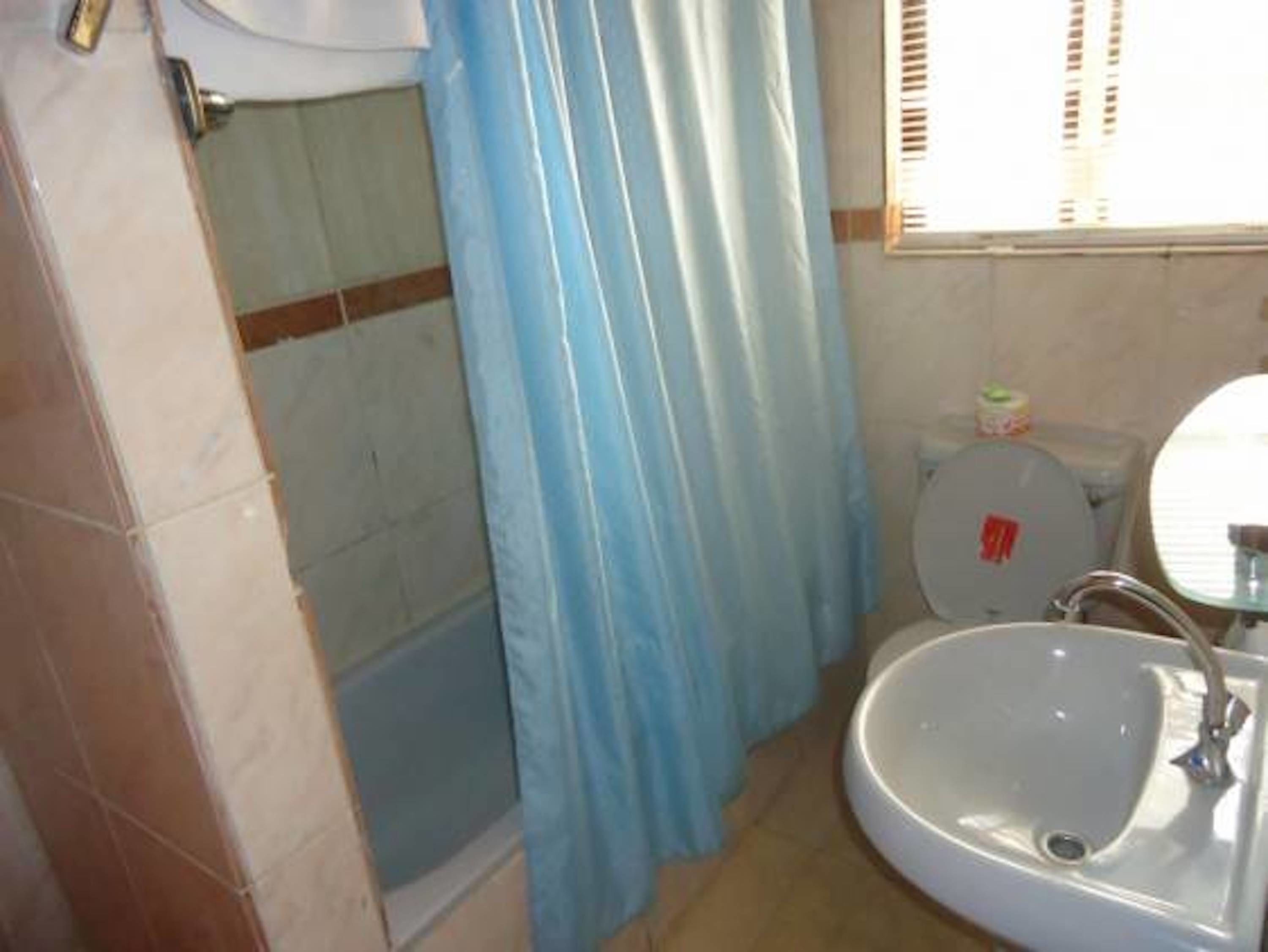 A bathroom with a bathtub, a toilet, and a sink.