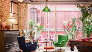 A cozy lounge area with a brick wall, a pool table, and comfortable seating. - Max Brown Hotel 7th District, part of Sircle Collection (Vienna)