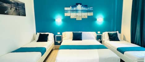 Triple Room, City View | Minibar, desk, blackout drapes, soundproofing