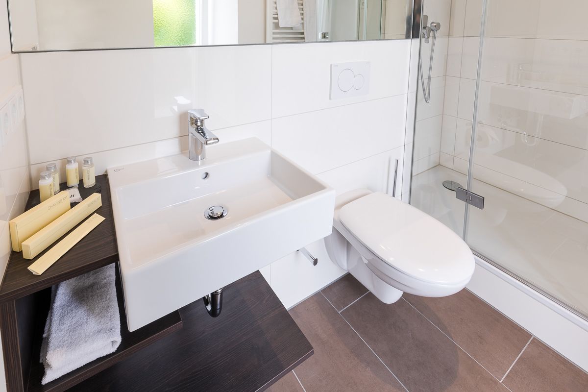 shower, hair dryer, slippers, towels