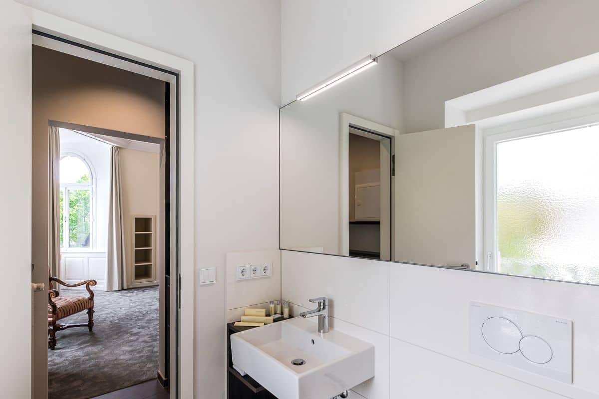 shower, hair dryer, slippers, towels