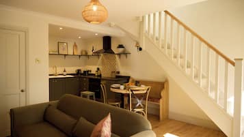 One Bedroom Cottage | Living area | Flat-screen TV, heated floors