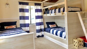 A bunk bed room with striped bedding, a ladder, and a view of the outside. - Perfect Summer backyard, Steps to Beach, Bikes, boogie-board, bunk beds, Grill (St Augustine)