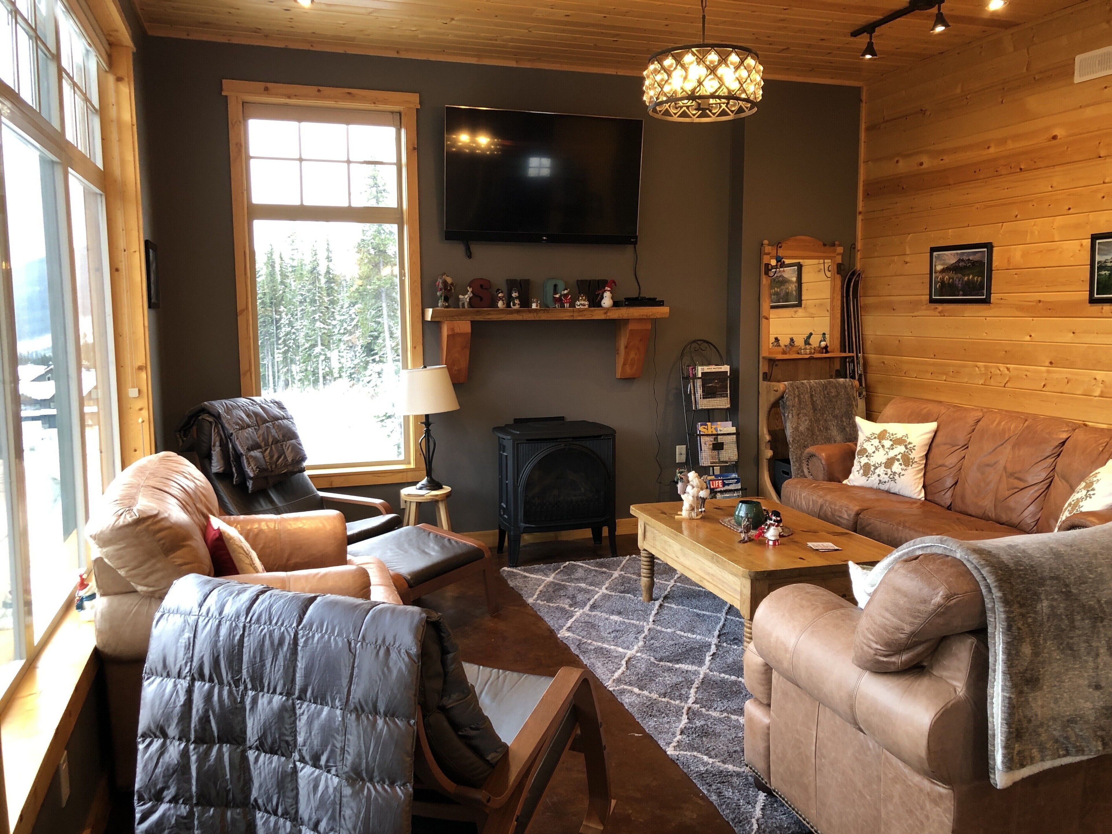 A cozy living room with a fireplace, a television, and a comfortable seating area.