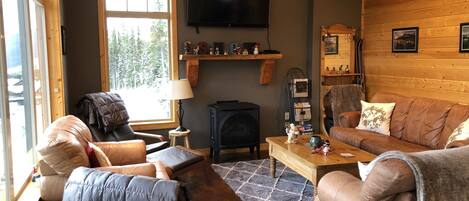 A cozy living room with a fireplace, a television, and a comfortable seating area.