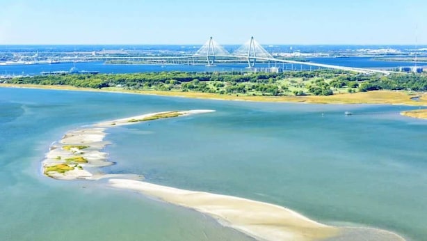 An aerial view of a coastal area with a bridge in the background. - Monaco Manor | Charleston Home w/ Rooftop Deck! (Charleston)
