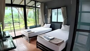 A room with two beds, a desk, and large windows. - Baan Rim Nam Resort (Phang Nga)