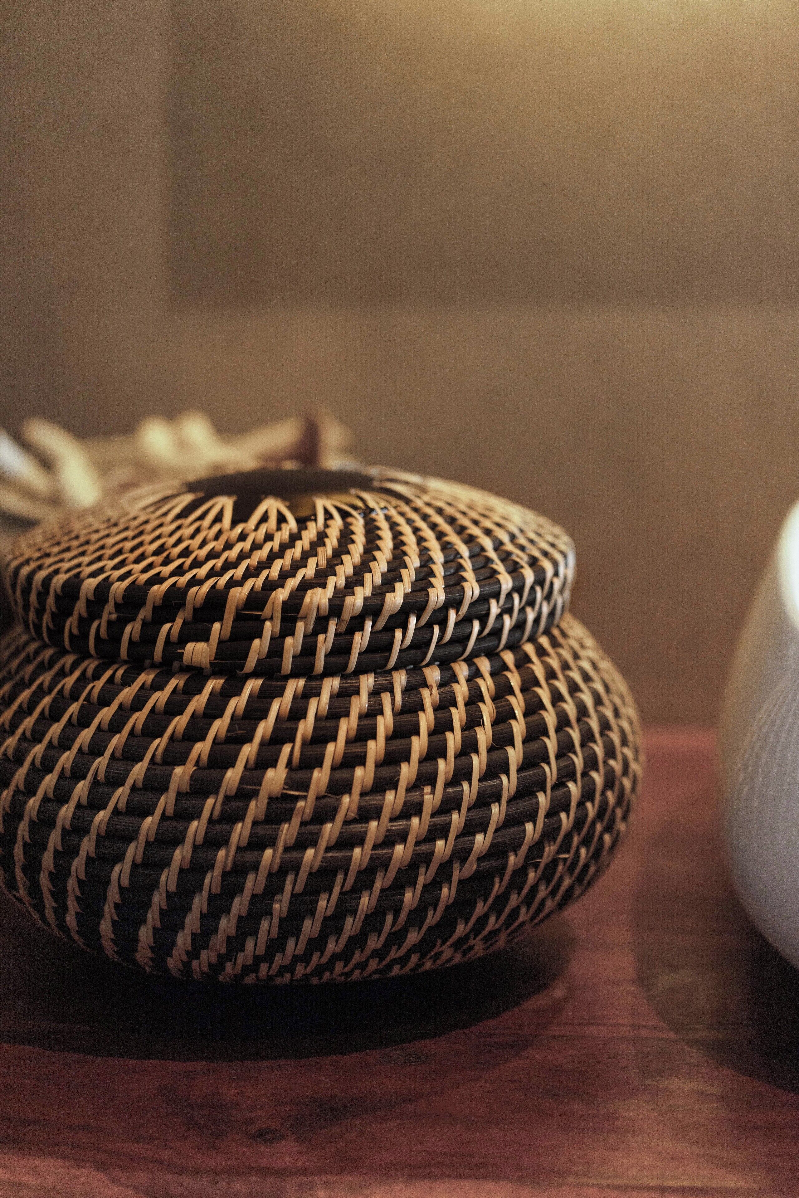 A close-up of woven baskets on a wooden surface.
