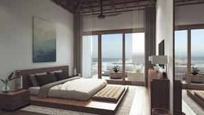 Un dormitorio moderno con una cama grande, vista al océano y un ventilador de techo.