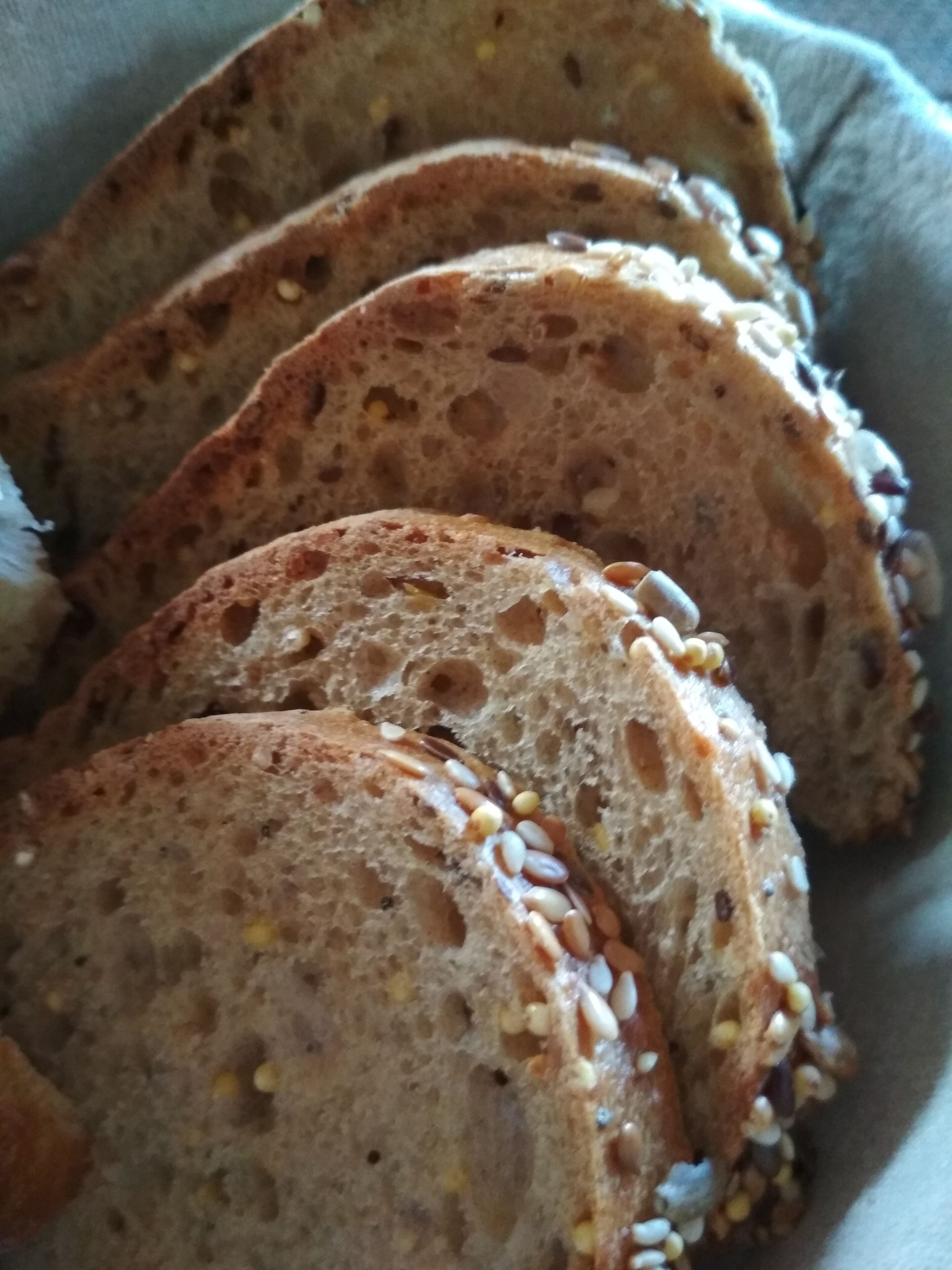 Slices of seeded bread with visible grains and seeds.