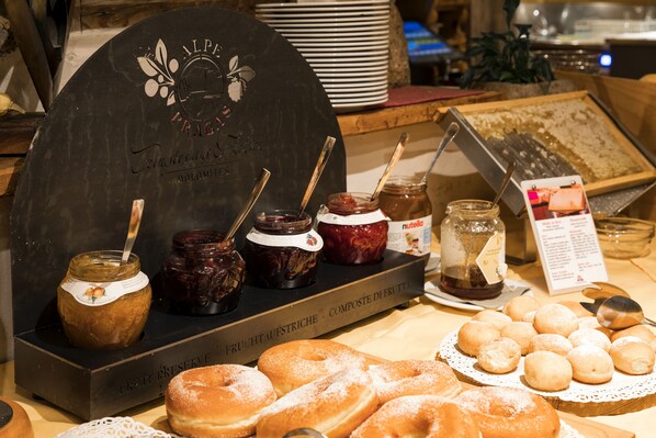 A display of pastries and jams with a sign reading "Alpine Prac."