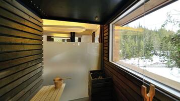 A modern interior with wooden slats on the walls, a bench, and a window with a view of a snowy forest.