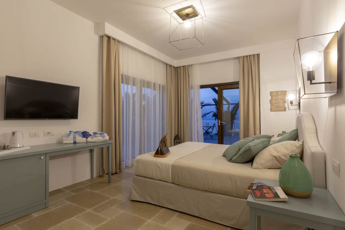 Junior suite, 1 slaapkamer, niet-roken, uitzicht op zee | 1 slaapkamer, donzen dekbedden, een kluis op de kamer, een bureau