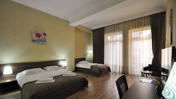 Family Triple Room | Minibar, in-room safe, desk, blackout curtains