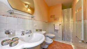A bathroom with two sinks, a toilet, a shower, and a towel rack. - Cozy Studio w/ Terrace & Unparalleled Location (Firenze)