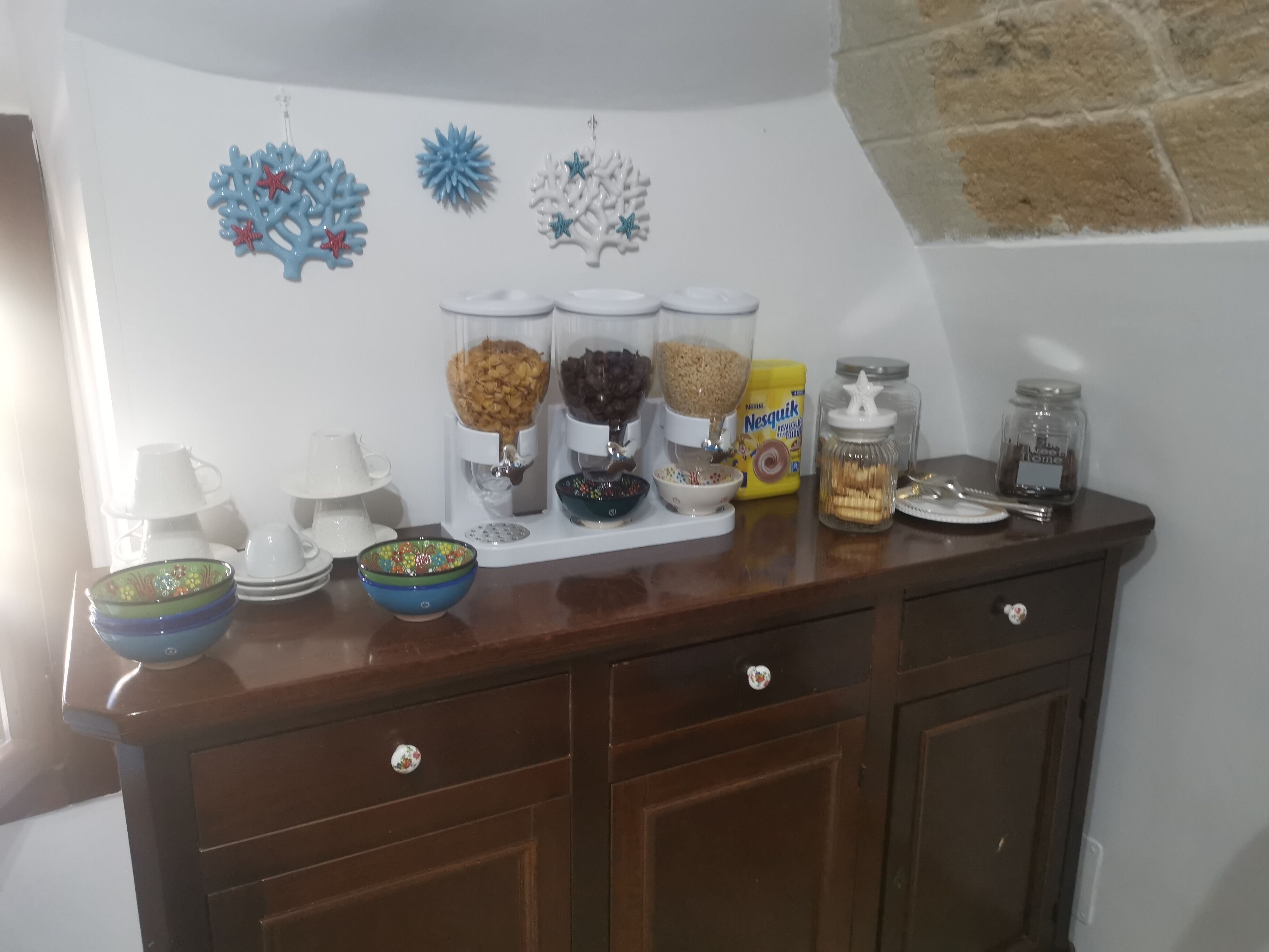 A kitchen counter with various food items and kitchenware.