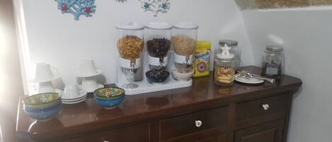 A kitchen counter with various food items and kitchenware.