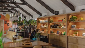 A modern interior with wooden shelves, a dining area, and a kitchen. - Bode Nashville (Nashville)