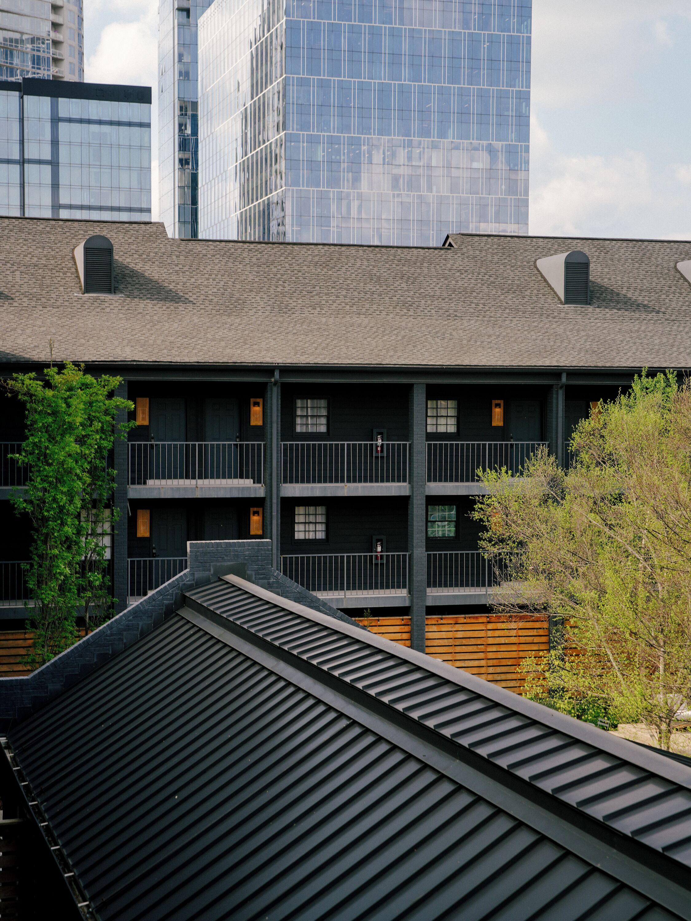 A multi-story building with a modern design, featuring a flat roof and large windows.
