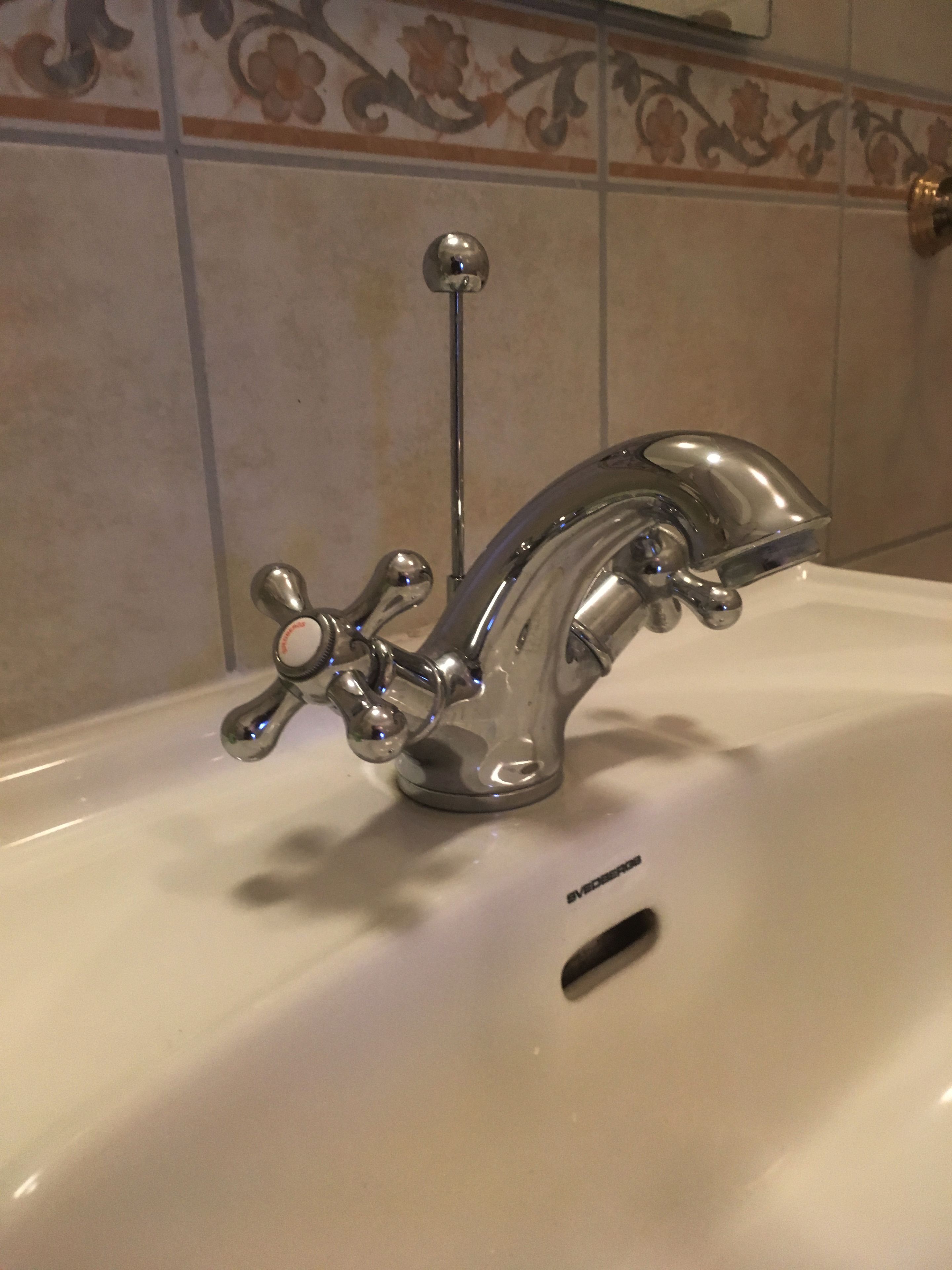 A bathroom sink with a chrome faucet and a single-handle design.