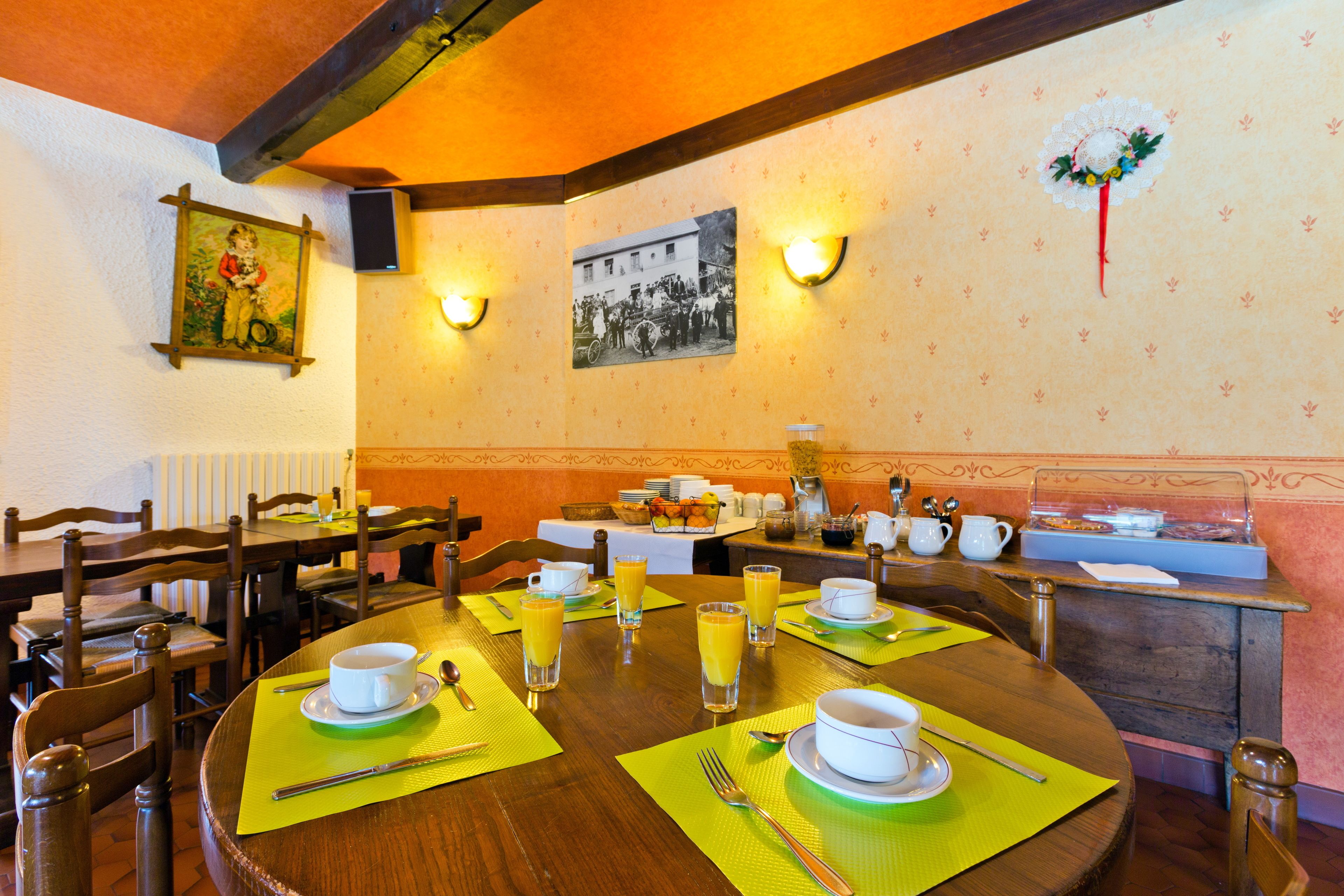 A dining area with wooden tables, chairs, and a buffet setup.