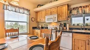 Una cocina con armarios de madera, un microondas y un lavabo.