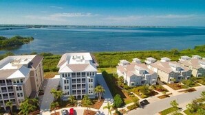 A residential area with modern houses, a marina, and a bridge in the background. - Waterfront on Anna Maria Sound ~ Beaches just minutes away! (Bradenton)