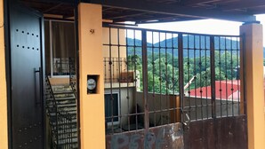 A gated entrance with a staircase leading to a balcony overlooking a mountainous landscape. - LOveFT The place to be t Valle de Bravo (Valle de Bravo)