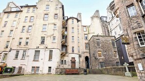 A historic building with multiple floors, a central spiral staircase, and a stone facade.