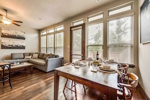 Relax in this inviting living area with a large dining table and comfortable seating.