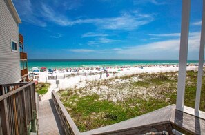 A beach view from a balcony with a wooden deck, a sandy beach, and a clear blue sky. - Free Amenities, Gulf-view! Private Beach! Pool! Ciboney 1009! (Destin)