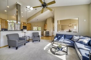 Relax in this stylish living area with a large sofa, coffee table, and armchairs.