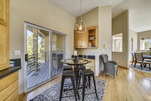 Enjoy meals and gatherings in this inviting kitchen and dining area with a seamless transition to the outdoor deck.