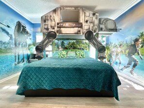 A bedroom with a Star Wars-themed mural, a bed with a teal quilt, and a large window overlooking a tropical landscape. - BEST HOUSE! StarWars Theater, HarryPotter, Princess, Pirates!!! Disney 8-10 min! (Kissimmee)