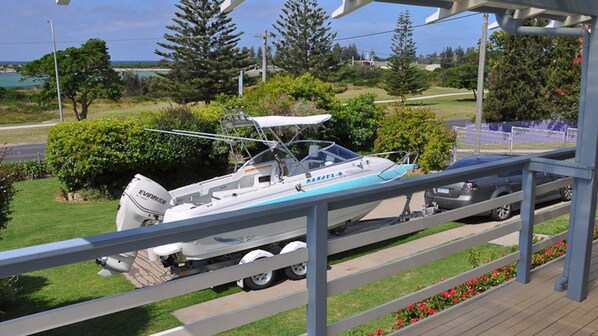 A boat parked on a wooden deck with a view of a coastal area. - Aberdeen 1 - Lamont Street 112 (BERMAGUI)