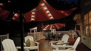A deck with white chairs and a table, surrounded by a wooden deck and a white railing. - Exclusive Low Country Island Estate Excellent Choice Of Large Groups,  (Charleston)
