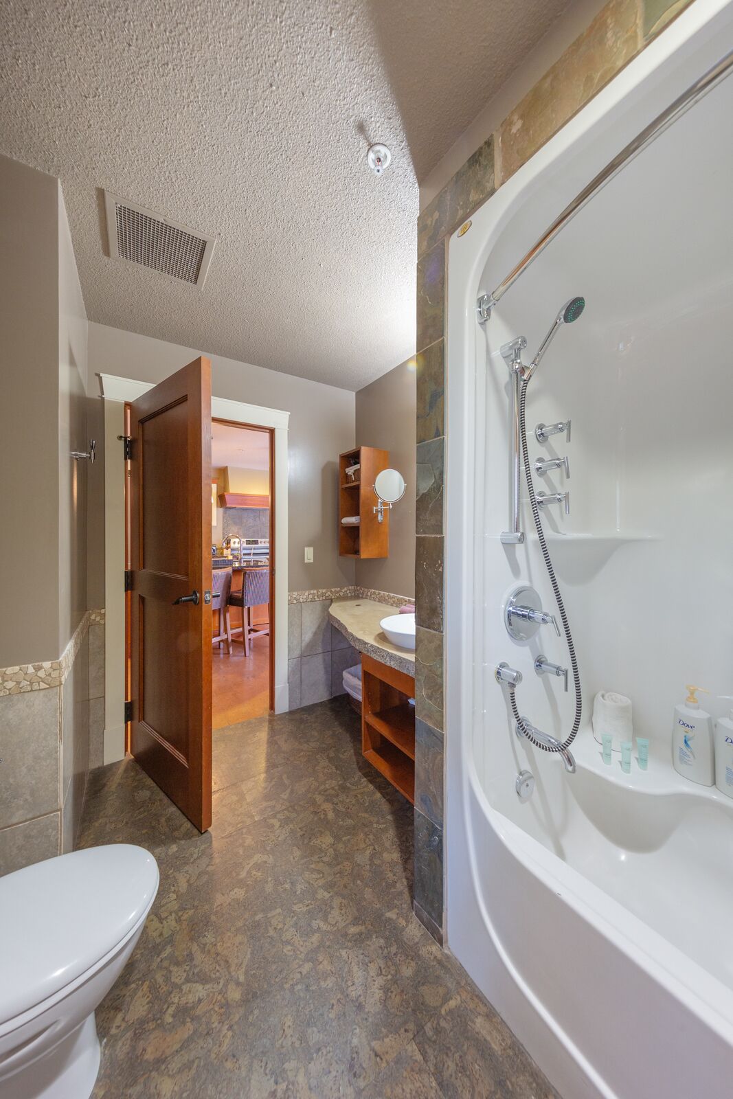 A bathroom with a bathtub, toilet, and sink.