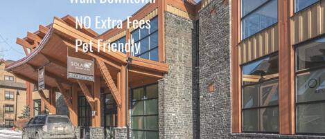 A modern building with a reception area, stone facade, and large windows.