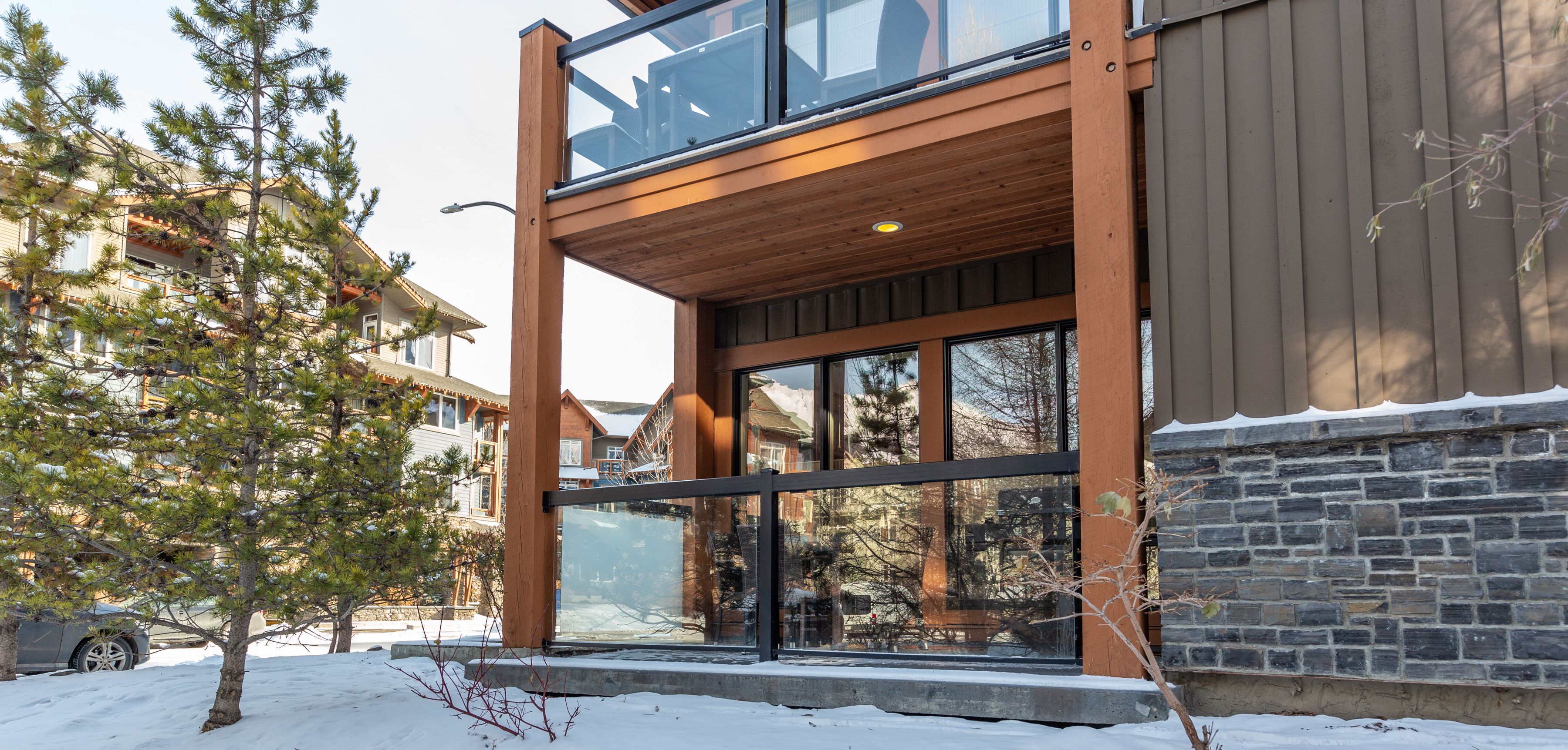 A pet-friendly hotel with a main floor and corner suite, featuring a stone facade and wooden accents.