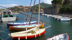 A harbor with several boats docked, a historic building, and a mountainous backdrop. - Spacious Three Bedroom Mountain Villa with Pool (Serdinya)