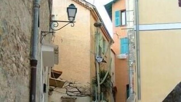 A narrow street with stone steps leading to a building entrance.