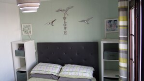 A bedroom with a bed, a headboard, a hanging light fixture, and wall decorations. - Relaxing, Poolside bungalow, 1 Bedroom luxury modern,  Sleeps 4 (Caleta de Fuste)