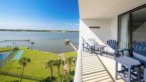 A balcony with Adirondack chairs and a sign reading "BEACH TOWELS". - Great Rates! Two Bedroom ~ Gulf Shores Surf & Racquet (Gulf Shores)