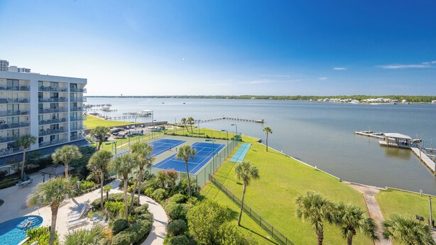 A hotel with a tennis court, pool, and waterfront view. - Great Rates! Two Bedroom ~ Gulf Shores Surf & Racquet (Gulf Shores)
