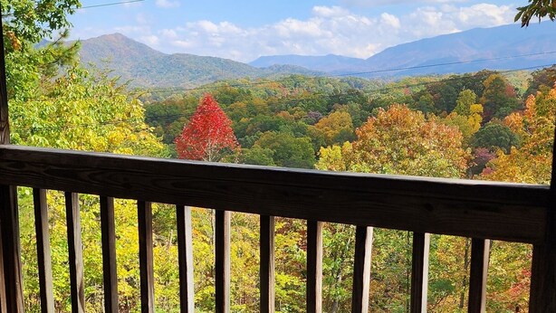 A hot tub with a wooden deck and a view of a mountainous landscape. - B's Nest a Private & Clean w Mtn Views & Hot Tubs! (Sevierville)