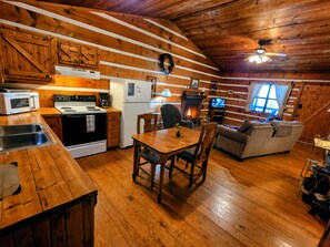 A cozy cabin interior with a kitchen, dining area, and living space. - B's Nest a Private & Clean w Mtn Views & Hot Tubs! (Sevierville)